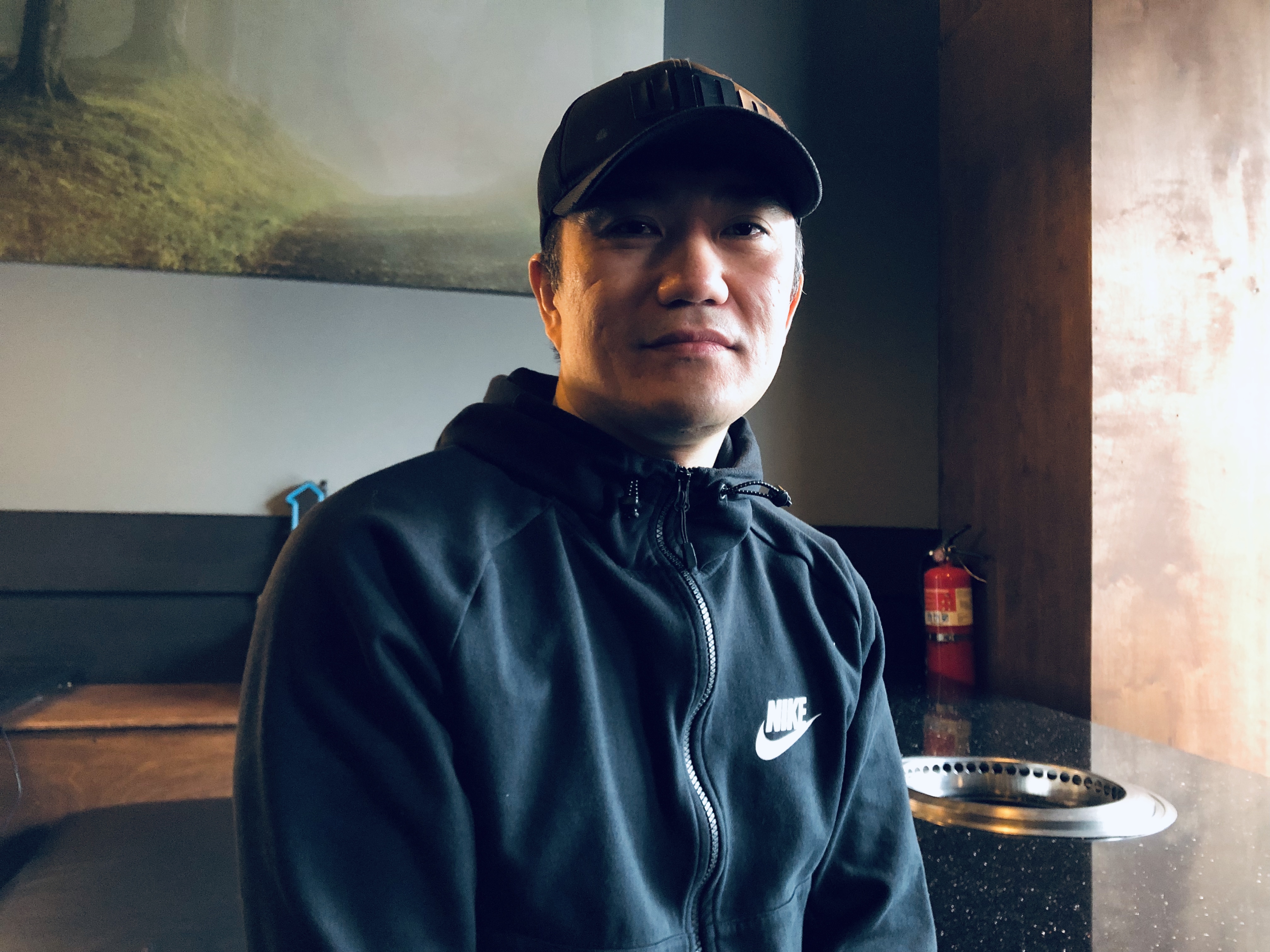 caption: Portrait of Andy Im, owner of Palmi Korean BBQ in the University District, poses for a portrait.
