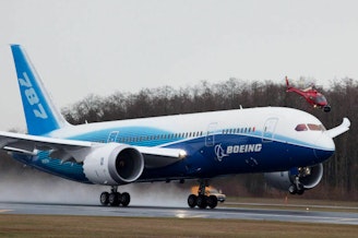 caption: A Boeing 787 Dreamliner accelerates down the runway during its first flight in December, 2009 in Everett, Wash.