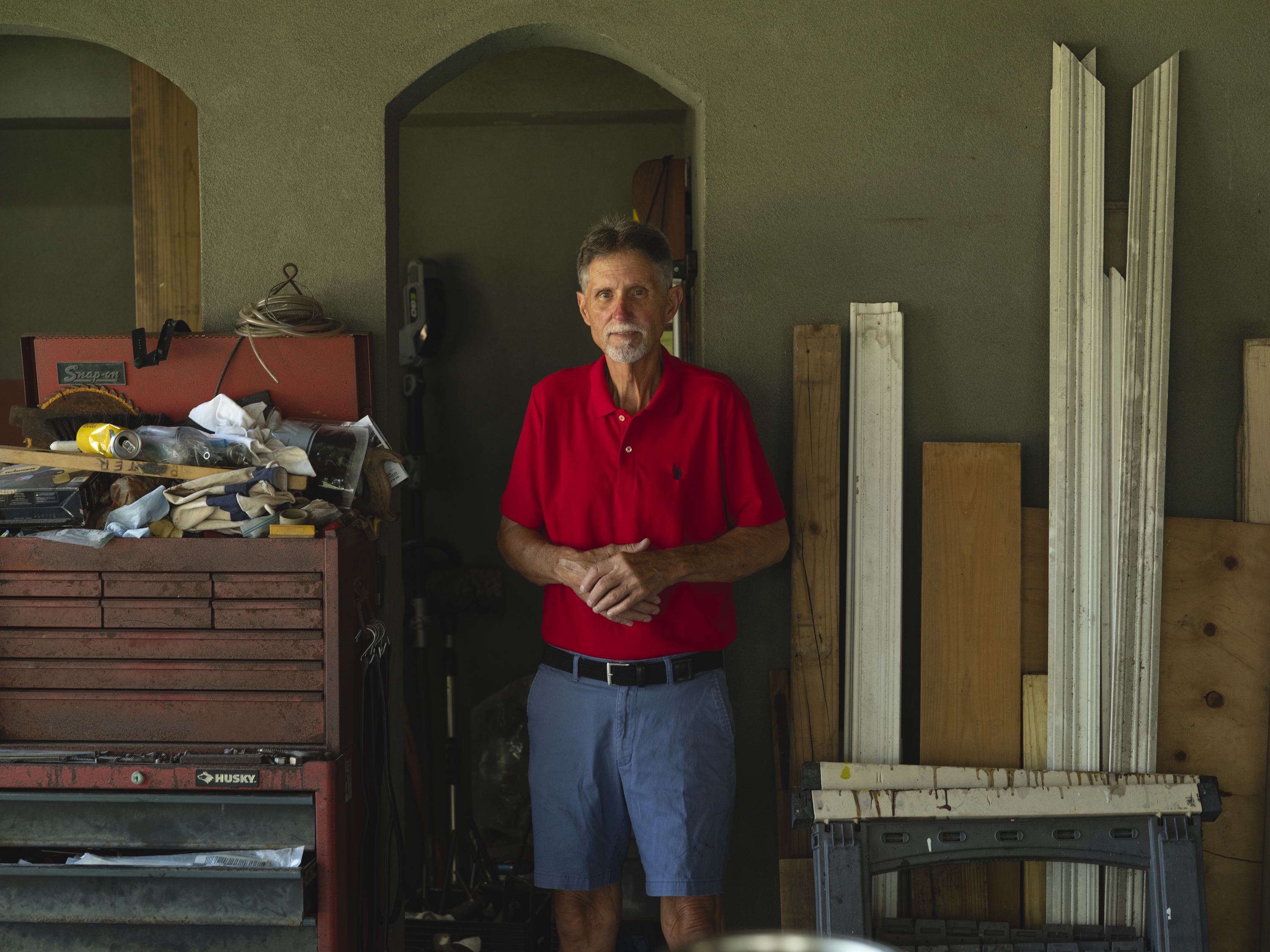 caption: Kevin Potter poses for a portrait in his home in Chalmette, St. Bernard Parish, on Aug. 20. He returned home after Hurricane Katrina. The neighborhood was flooded due to the nearby Mississippi River–Gulf Outlet Canal shipping channel, which did not have a storm surge barrier at the time.