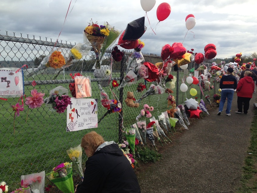 caption: Balloons and flowers at an impromptu memorial at Marysville Pilchuck High School the Monday after a school shooting on Friday, Oct. 24.