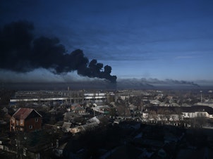 caption: Black smoke rises from a military airport in Chuguyev near Kharkiv on February 24, 2022. - Russian President Vladimir Putin announced a military operation in Ukraine today with explosions heard soon after across the country and its foreign minister warning a "full-scale invasion" was underway.