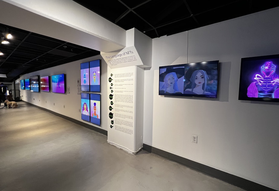 caption: The Seattle NFT Museum is designed to be familiar, offering classic exhibition stylings alongside informational walkthroughs of how NFTs work.