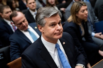 caption: FBI Director Christopher Wray, pictured on Capitol Hill on Feb. 5, is briefing House members on security threats on Thursday.