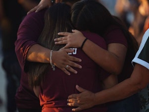 caption: People mourn Wednesday as they attend a vigil for the victims of the mass shooting at Robb Elementary School in Uvalde, Texas.