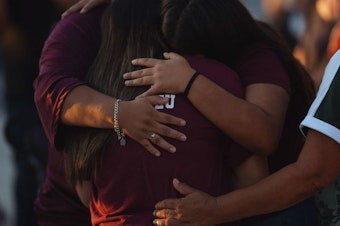 caption: People mourn Wednesday as they attend a vigil for the victims of the mass shooting at Robb Elementary School in Uvalde, Texas.