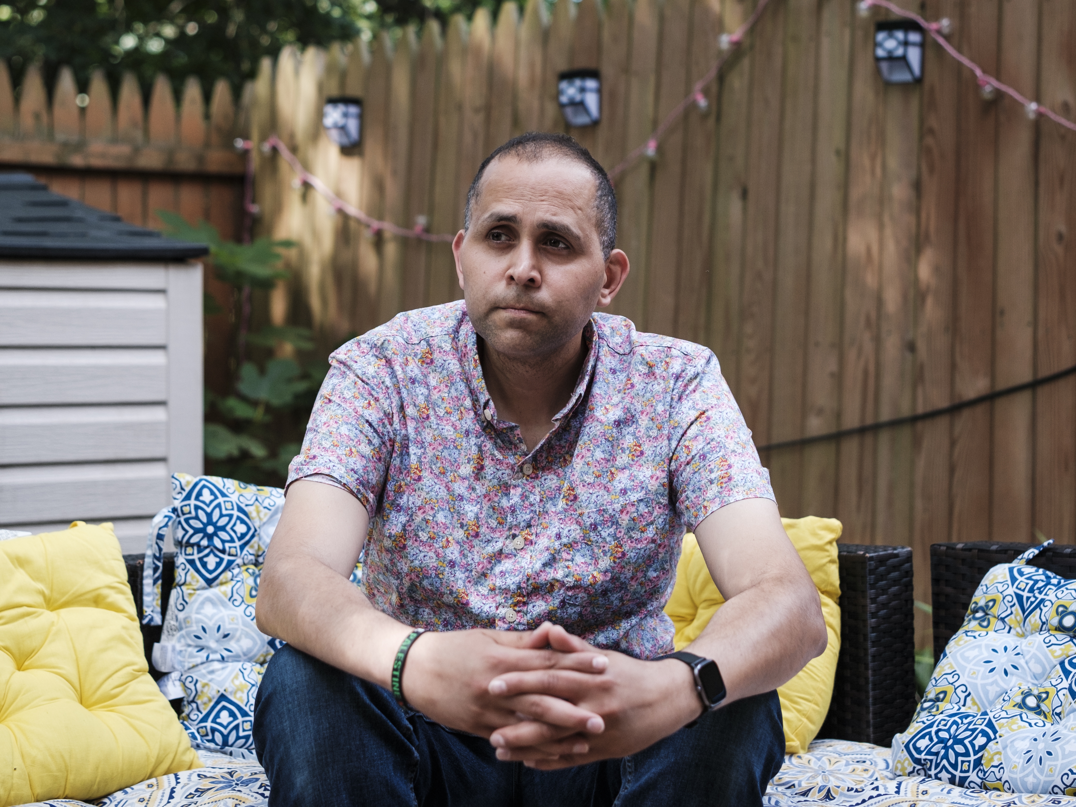 caption: Hani Almadhoun, a Palestinian-American, poses for a portrait at his home in Virginia on June 26.