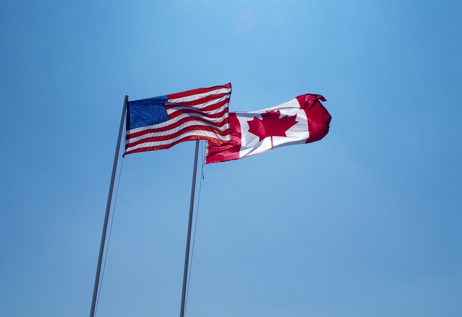 caption: Canadian flag and American flag