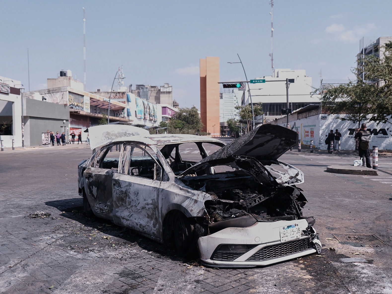 caption: A vehicle sits charred after being set on fire, on a road in Guadalajara, Jalisco state, Mexico, Sunday, Feb. 22, 2026, after the death of the leader of the Jalisco New Generation Cartel, Nemesio Rubén Oseguera Cervantes, known as"El Mencho."