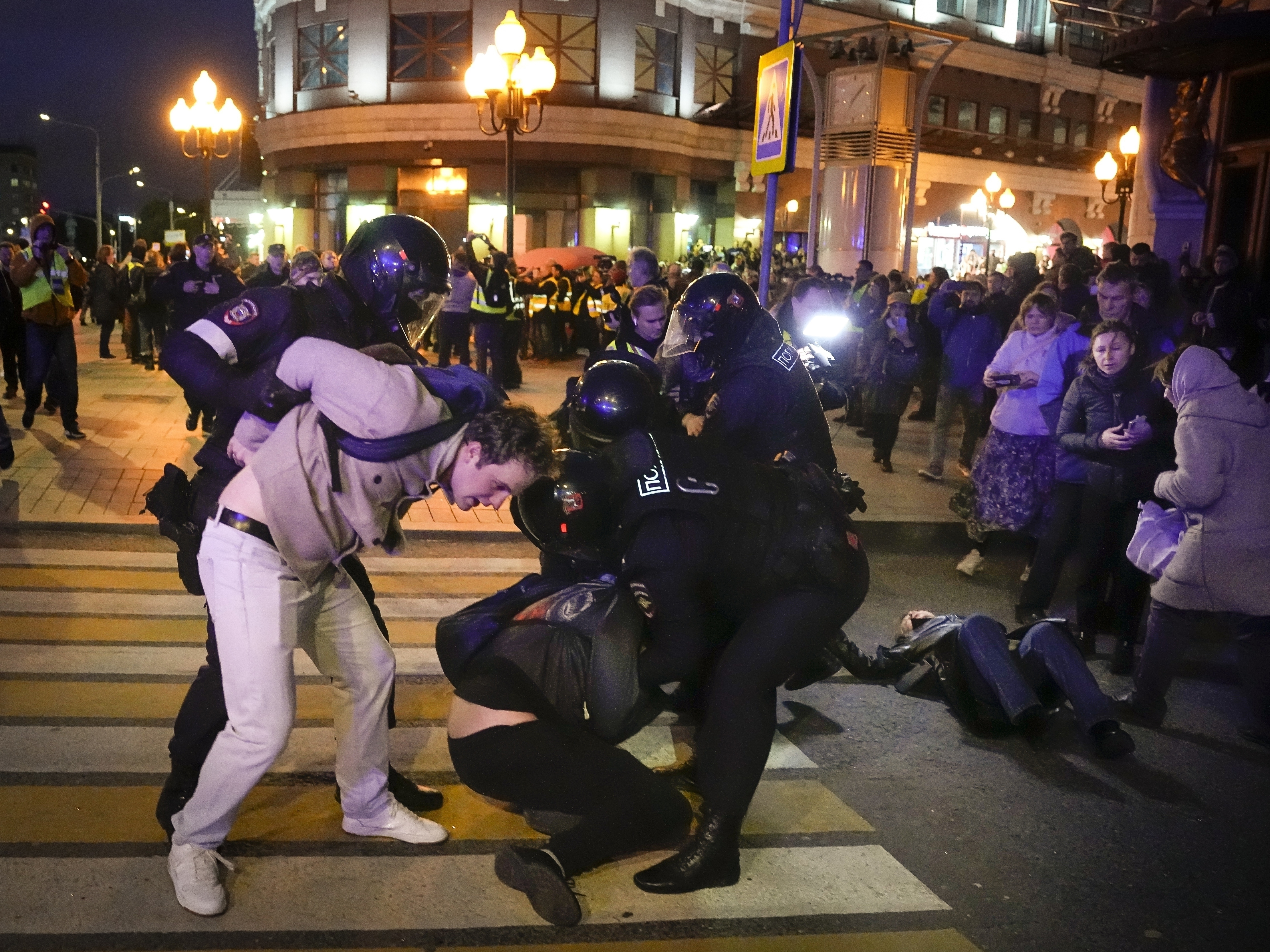 caption: Riot police detain demonstrators during a protest against mobilization in Moscow on Wednesday. Russian President Vladimir Putin ordered a partial mobilization of reservists in Russia, effective immediately.