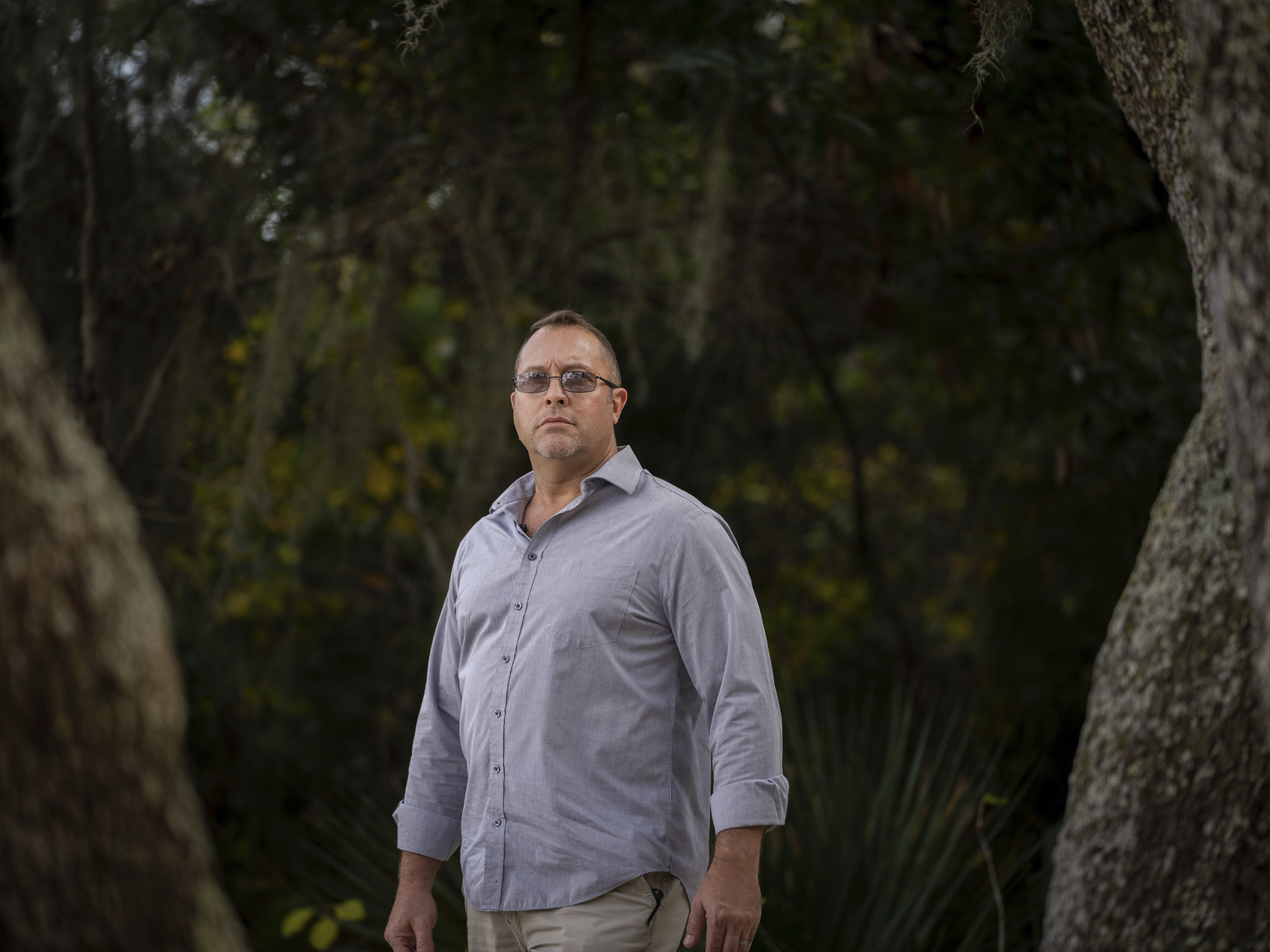 caption: Joseph Moore stands for a portrait at a park in Jacksonville, Fla., earlier this month. Moore worked for nearly 10 years as an undercover informant for the FBI, infiltrating the Ku Klux Klan in Florida, foiling at least two murder plots, according to investigators, and investigating ties between law enforcement and the white supremacist organization.