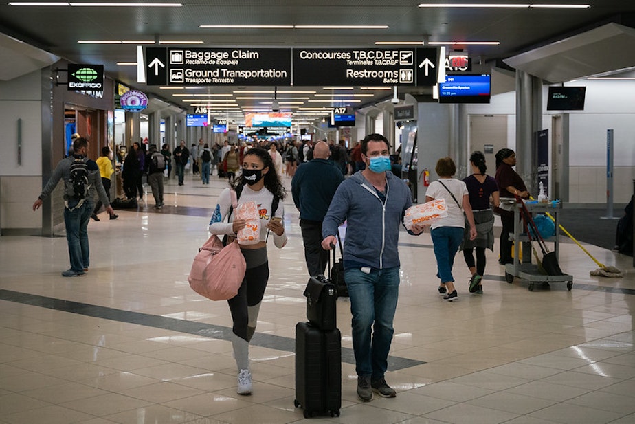 caption: Flyers at Hartsfield-Jackson Atlanta International Airport wearing facemasks.