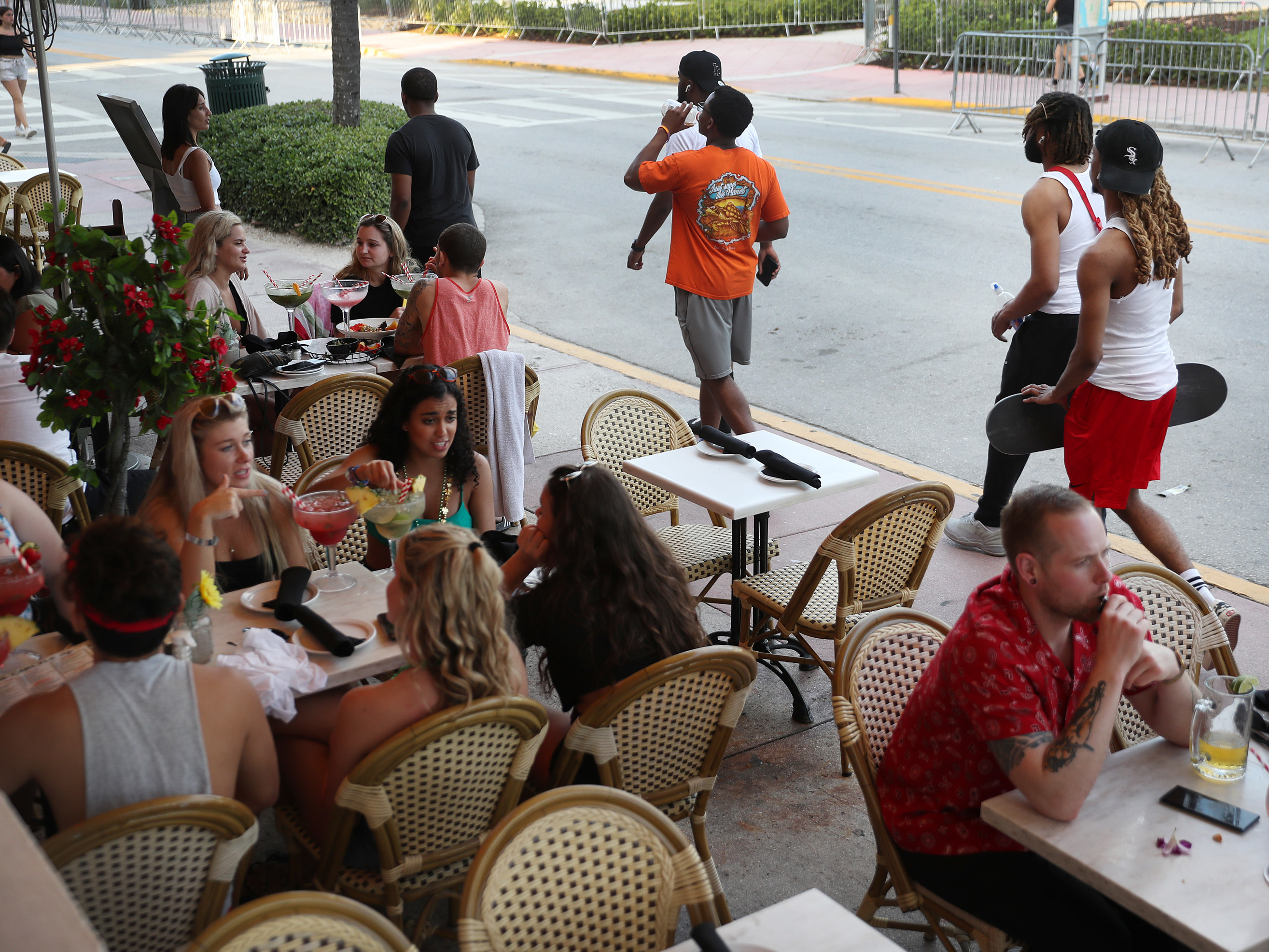 caption: As late as March 17, people eat at a restaurant along Ocean Drive in Miami Beach, Fla., several days after President Trump declared a national emergency.