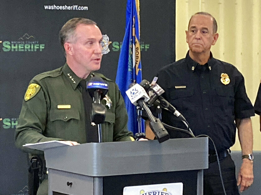 caption: Washoe County Sheriff Darin Balaam, left, answers a reporter's question as fire officials look on Tuesday during a news conference in Reno, Nev., about the accident that seriously injured actor Jeremy Renner on a private mountain road near Lake Tahoe on New Year's Day.