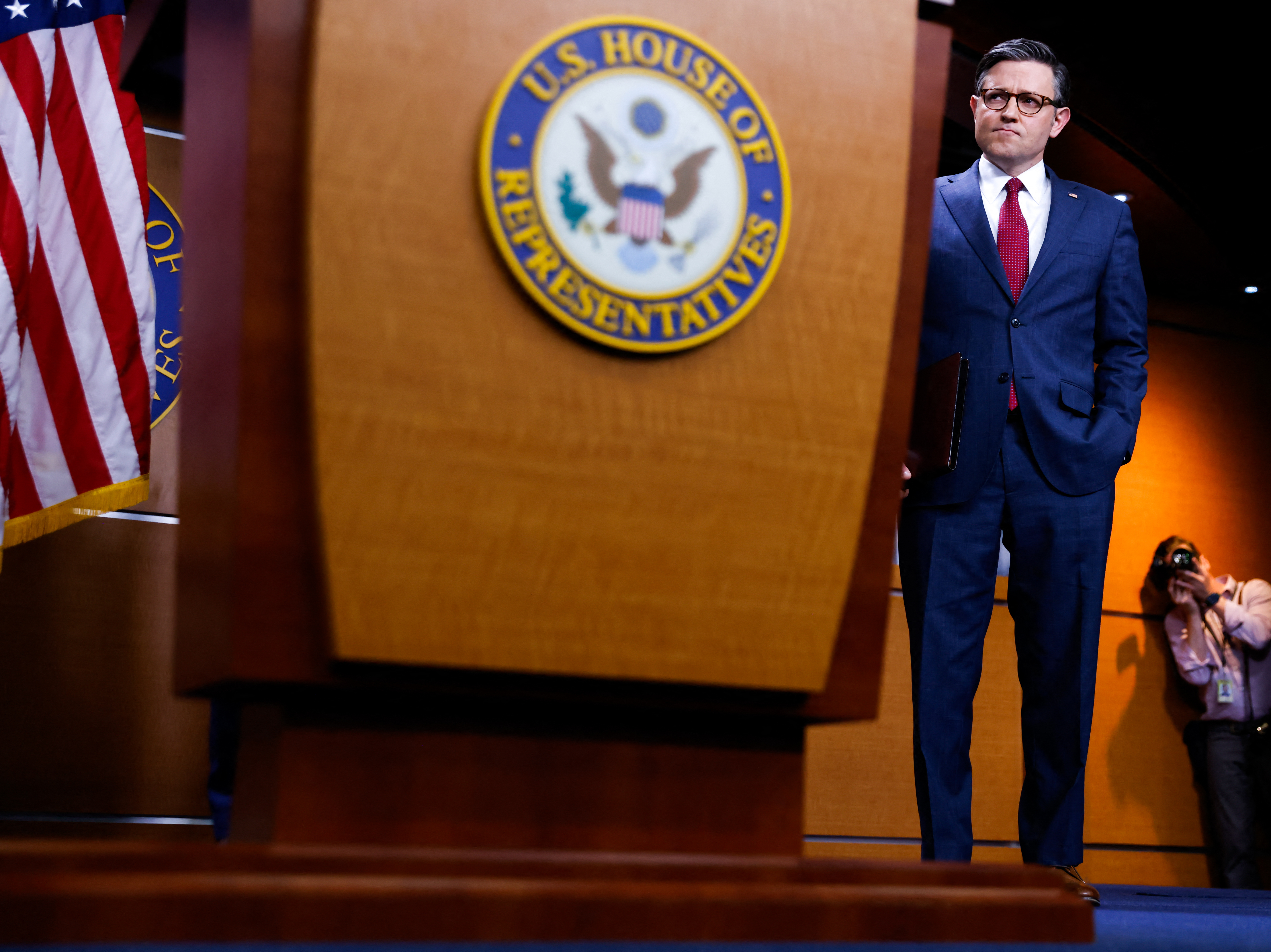 caption: Speaker of the House Mike Johnson attends a news conference at the U.S. Capitol earlier this month.