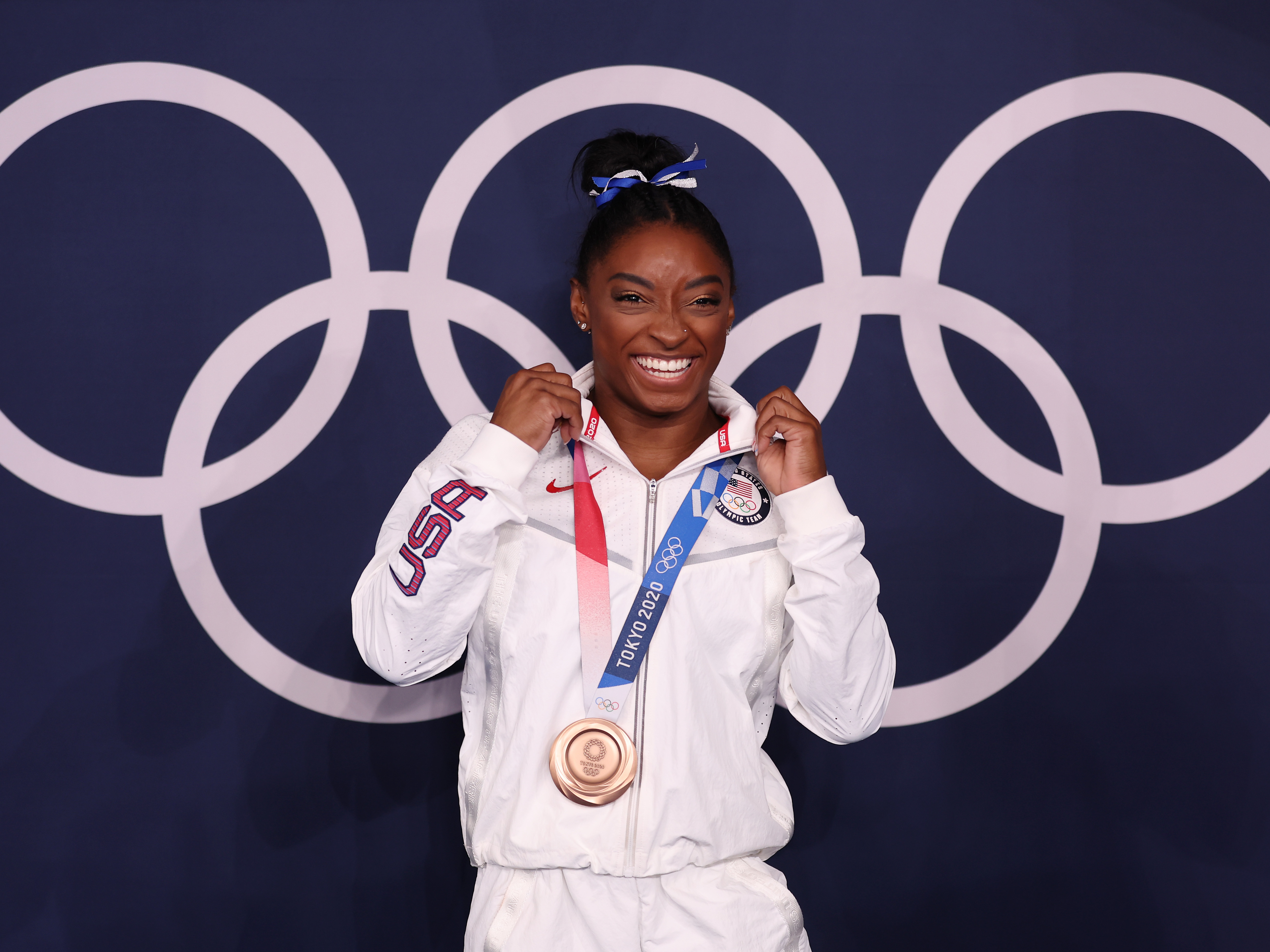 caption: U.S. gymnast Simone Biles won a bronze medal Tuesday in the women's balance beam final at the Tokyo Olympic Games.