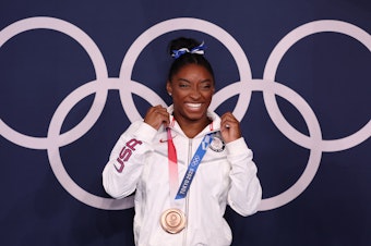 caption: U.S. gymnast Simone Biles won a bronze medal Tuesday in the women's balance beam final at the Tokyo Olympic Games.