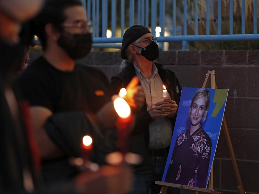 caption: New Mexico residents attend a candlelight vigil to honor cinematographer Halyna Hutchins in Albuquerque, N.M. Saturday, Oct. 23, 2021. Hutchins was fatally shot on Thursday on the set of a Western filmed in Santa Fe, N.M.