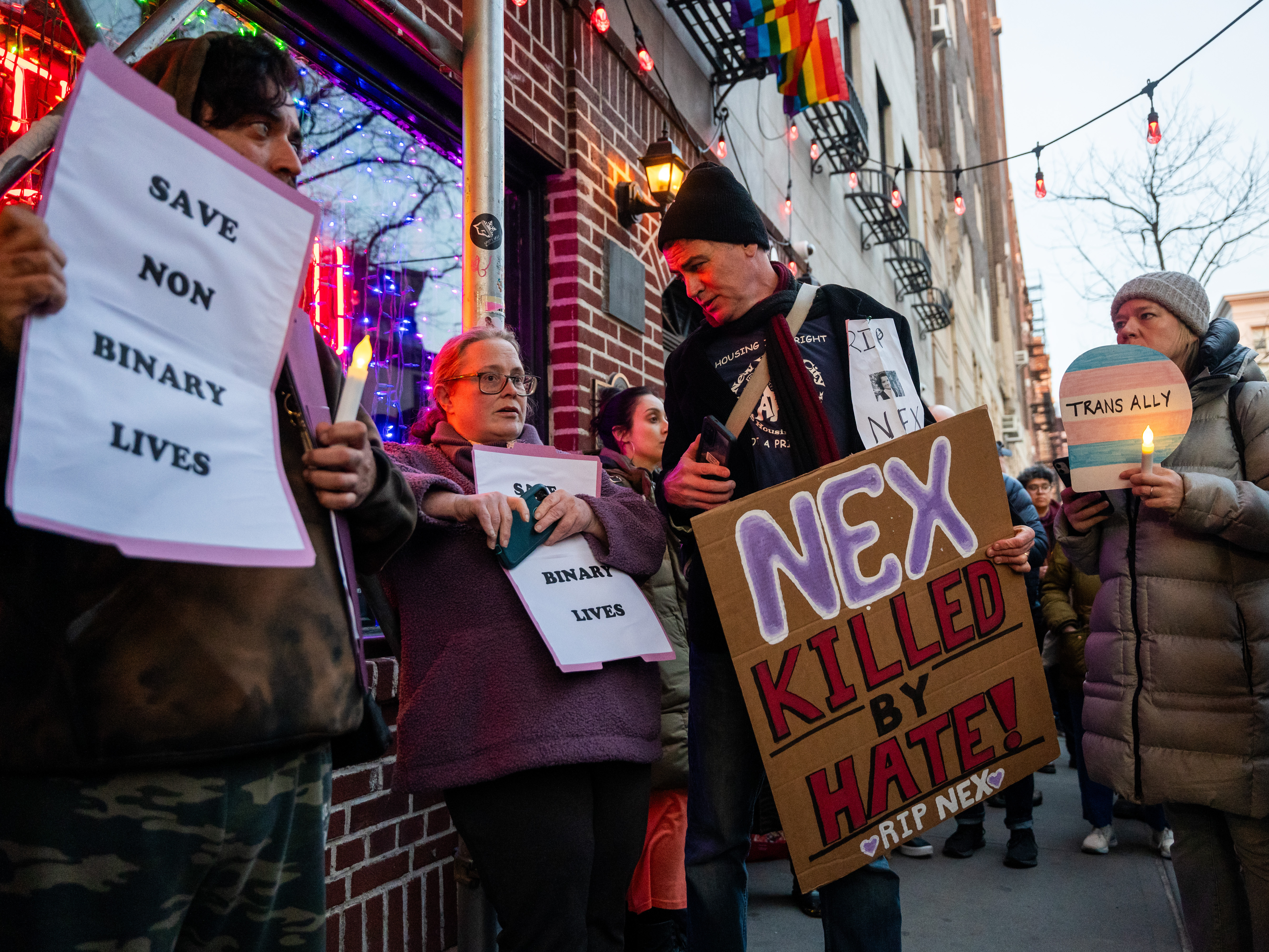 caption: People gather outside the Stonewall Inn on Feb. 26 in New York City for a vigil for Nex Benedict, a 16-year-old who identified as nonbinary.