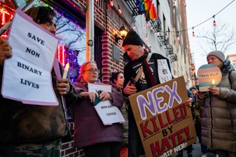 caption: People gather outside the Stonewall Inn on Feb. 26 in New York City for a vigil for Nex Benedict, a 16-year-old who identified as nonbinary.