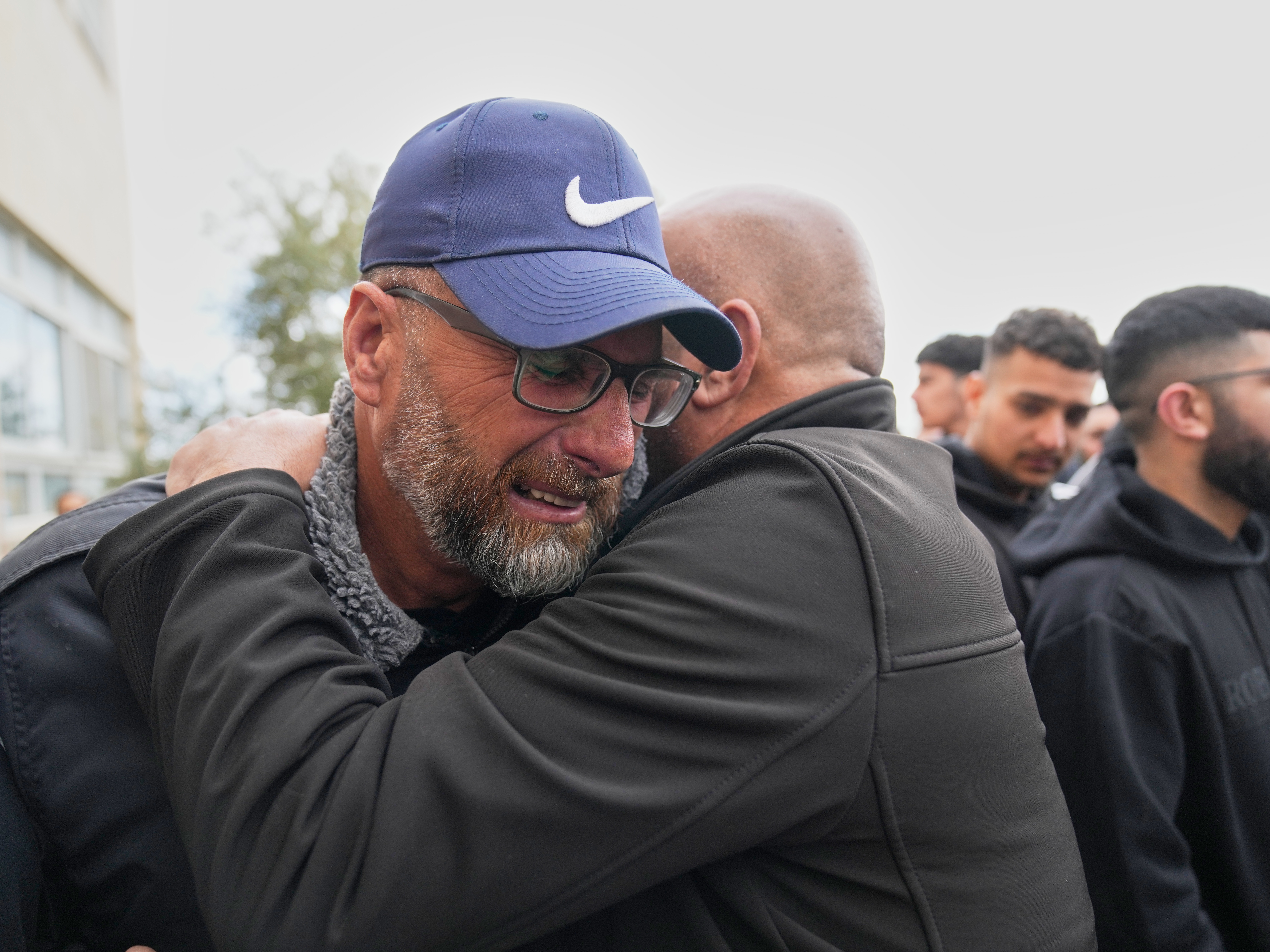 caption: Mourners give condolences to Mohammad Abu Siyam, the father of Palestinian-American Nasrallah Abu Siyam, 19, who according to the Palestinian Health Ministry was shot by settlers on Wednesday night, during his funeral in the West Bank village of Mukhmas, east of Ramallah, Thursday, Feb. 19, 2026.