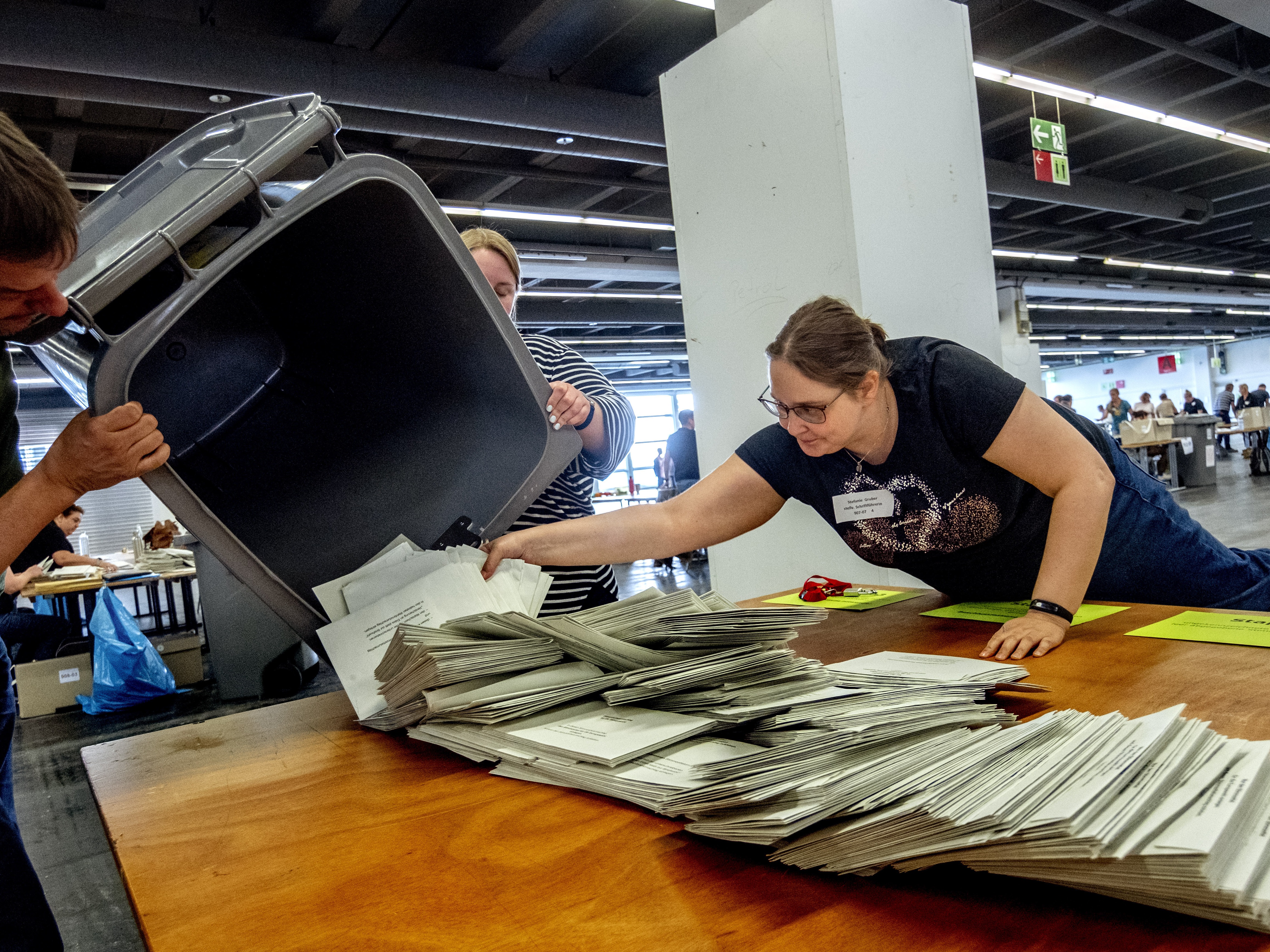 caption: Elections workers empty a bin to count postal ballots for the European Union elections in Frankfurt, Germany, on Sunday, June 9, 2024.