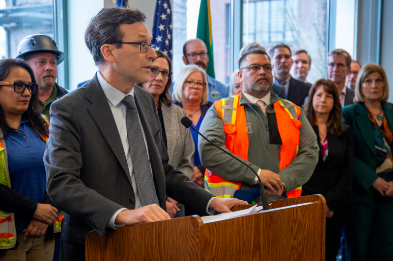 caption: Washington Gov. Bob Ferguson during a press conference in Vancouver, Wash., March 17, 2026, discussing the rising cost of the Interstate Bridge.
