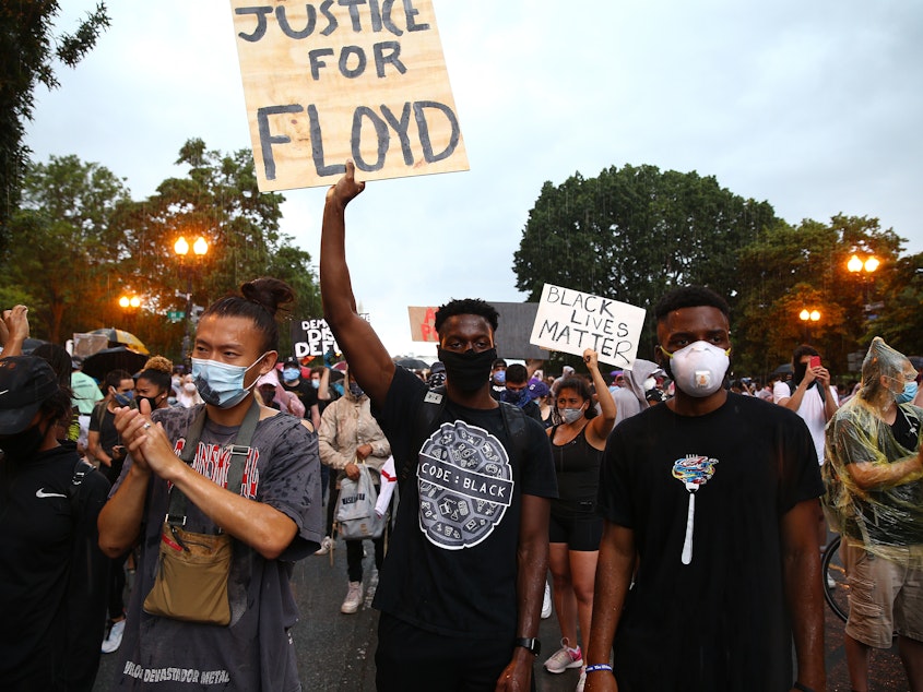 caption: Demonstrators gather on 16th St. near Lafayette Park during a peaceful protest against police brutality and the death of George Floyd, on June 5, 2020 in Washington, DC.