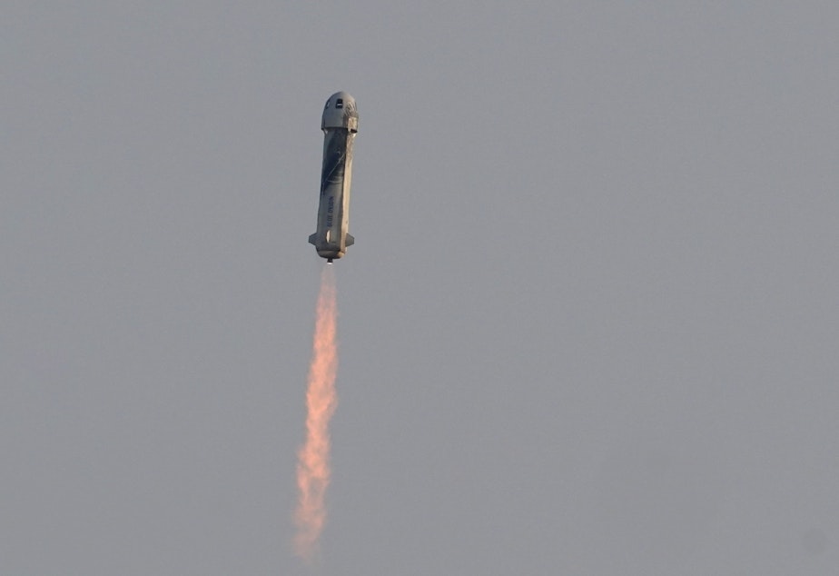 caption: Blue Origin's New Shepard rocket launches on Tuesday morning, carrying passengers Jeff Bezos, founder of Amazon and space tourism company Blue Origin; his brother, Mark Bezos; 82-year-old female aviation pioneer Wally Funk; and 18-year-old Oliver Daemen from its spaceport near Van Horn, Texas.