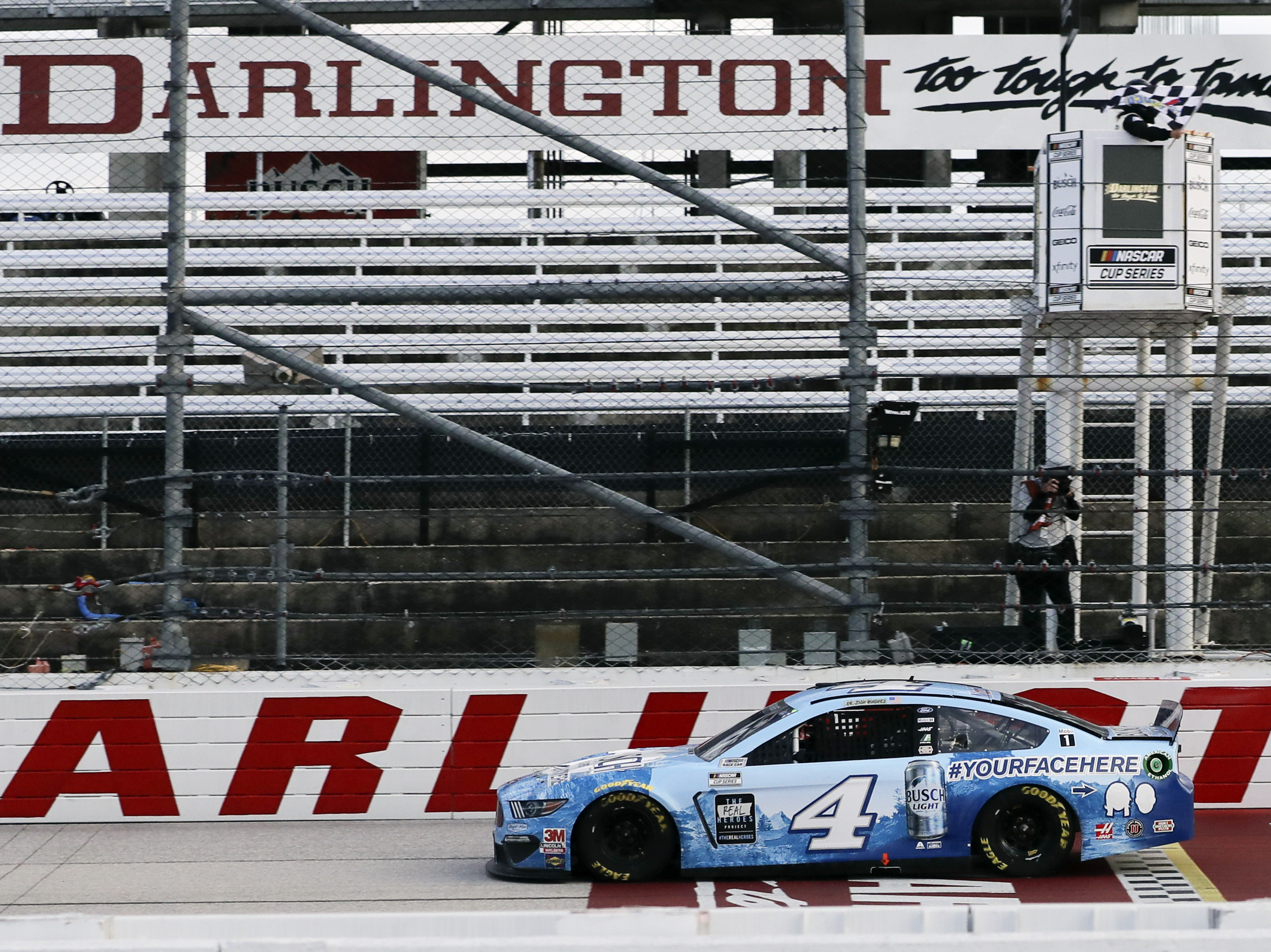 caption: Kevin Harvick crosses the finish line to win the NASCAR Cup Series auto race Sunday in Darlington, S.C. It's the first NASCAR race since March.