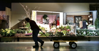 caption: A worker pulls a wagon at the Northwest Flower & Garden Show in 2013, in Seattle. The convention center has plans to expand yet again.