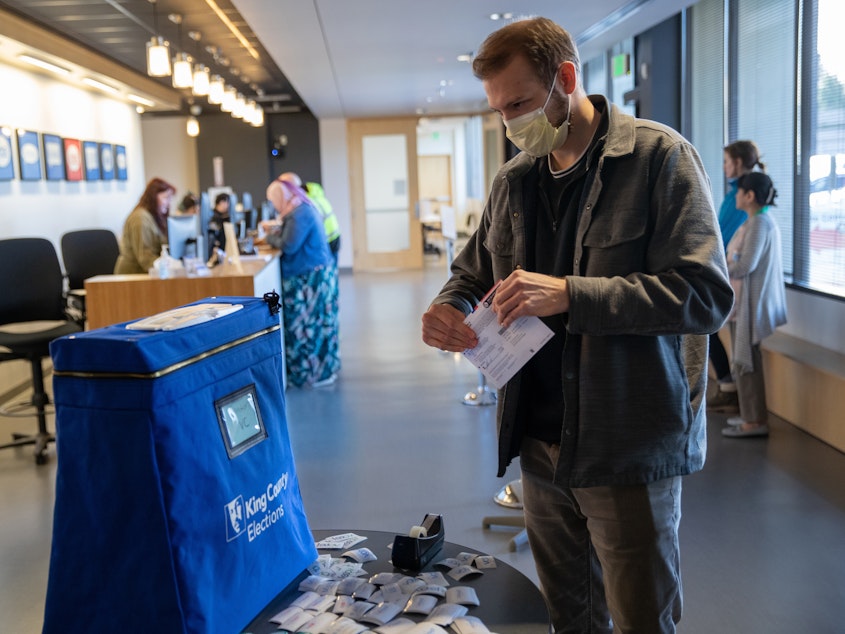 caption: Taylor Miller prepares to cast his ballot during early voting at the King County Elections processing center on March 9, in Renton, Wash. King County has had the highest number of deaths in the U.S. due to the coronavirus outbreak.