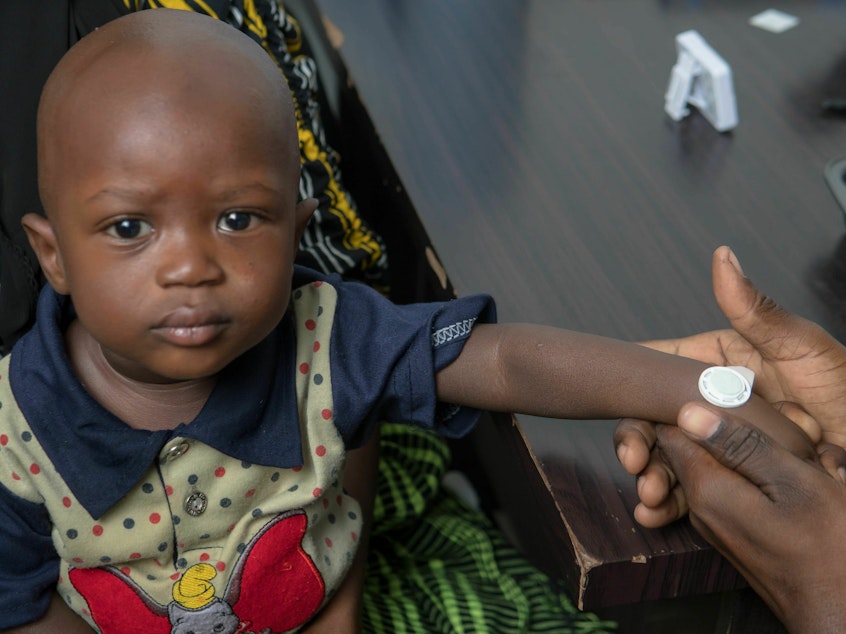 caption: Study participants in The Gambia received a measles vaccine through a virtually pain-free sticker. Early data on adults and children as young as nine months suggest the syringe-free skin patch is safe and effective.