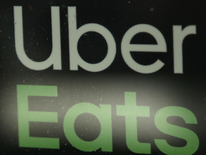 caption: Uber Eats is in talks with Grubhub about a possible acquisition. Analysts say such a merger would make the combined company the dominant player in food delivery.