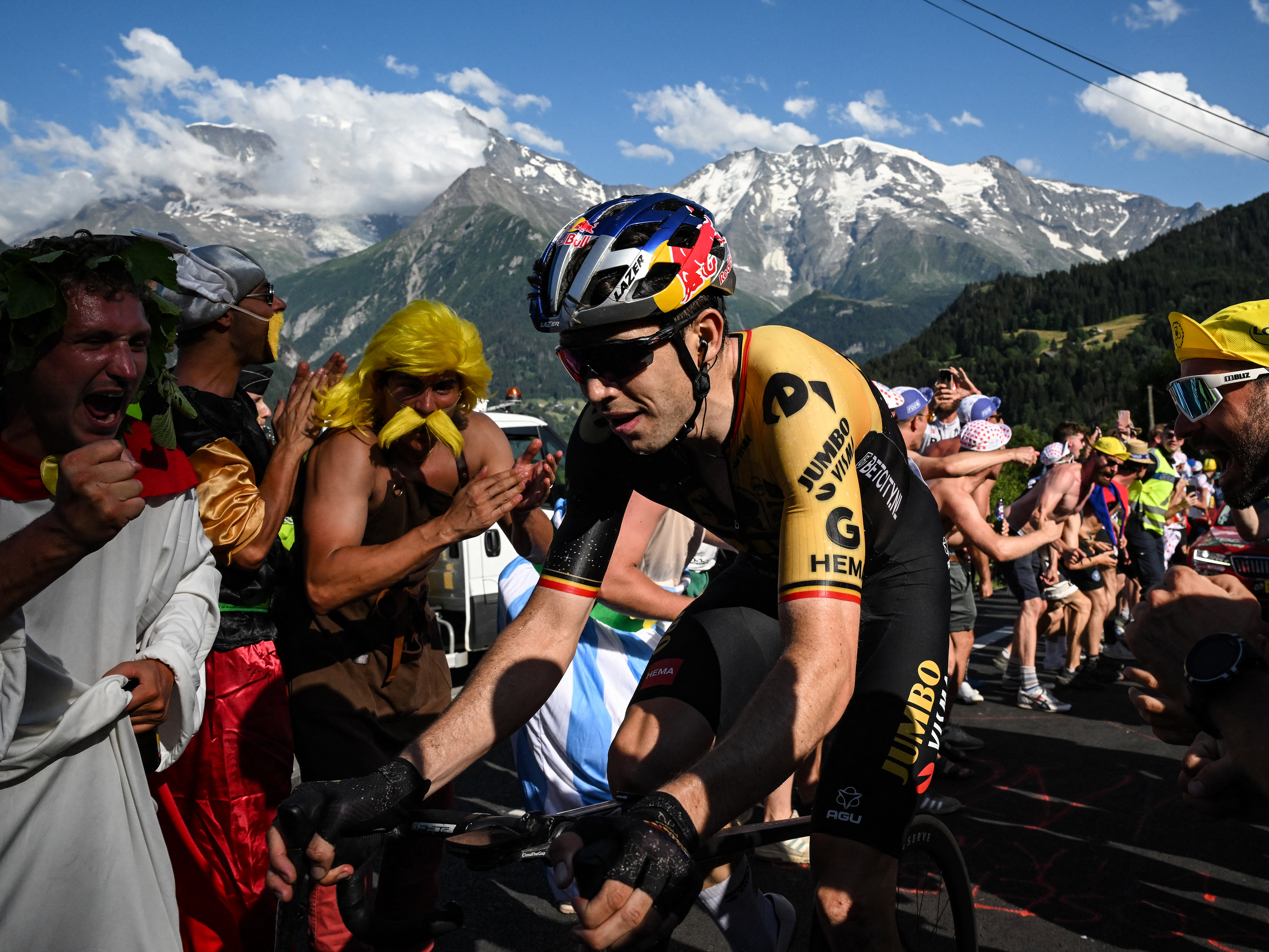 caption: Wout van Aert is abandoning the Tour de France after learning that his pregnant wife's labor is "imminent." He's seen here earlier this week, ascending Saint-Gervais-les-Bains in the French Alps.