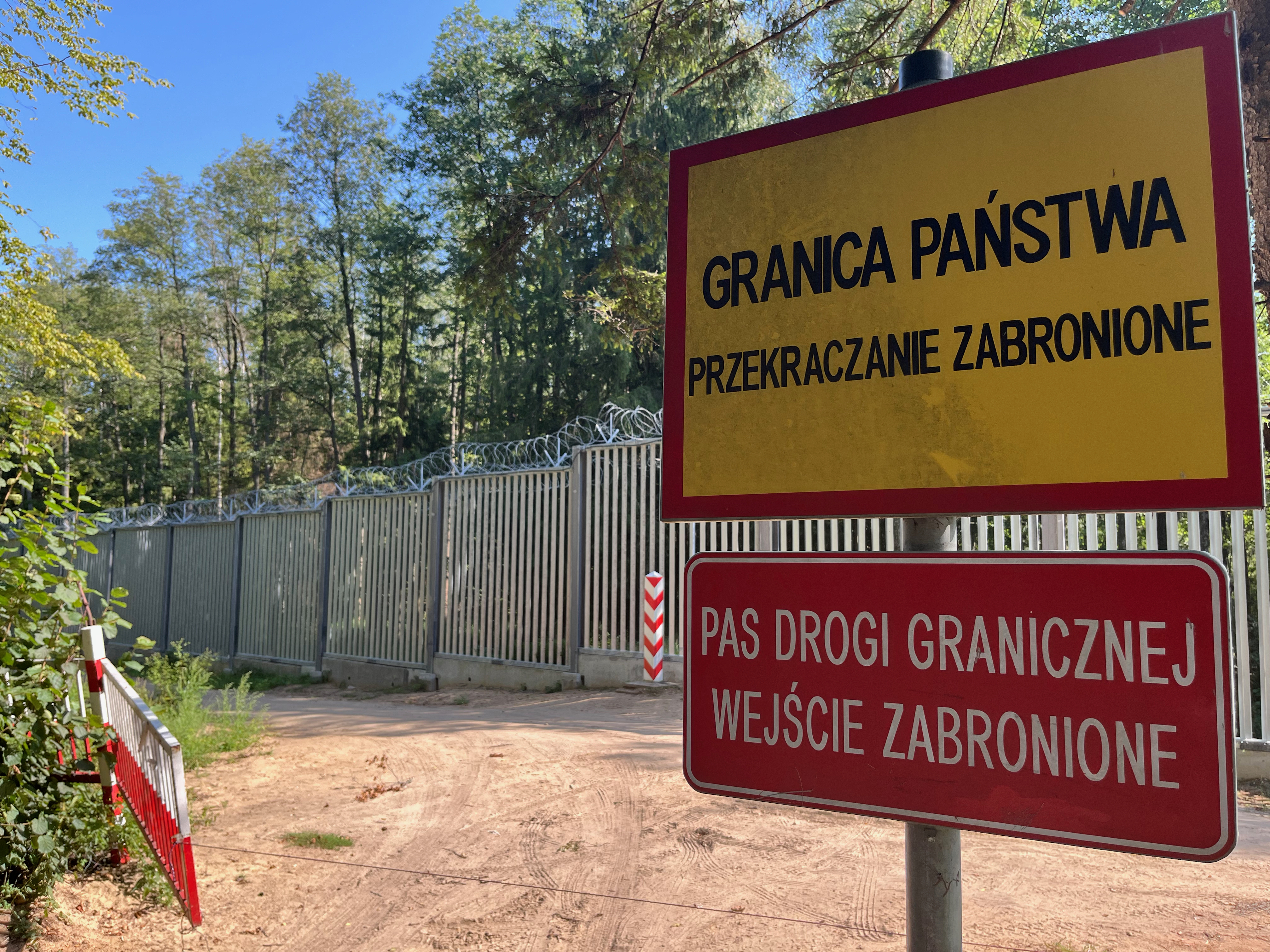 caption: In the middle of Poland's Bialowieza Forest, one of Europe's oldest remaining forests, stands Europe's newest border wall: a 15-foot-high metal fence topped with razor wire and security cameras. Poland finished building this fence a year ago to try to stem an influx of migrants assisted to the border by Belarusian soldiers, whose government is trying to destabilize Europe.