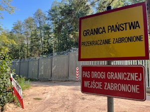 caption: In the middle of Poland's Bialowieza Forest, one of Europe's oldest remaining forests, stands Europe's newest border wall: a 15-foot-high metal fence topped with razor wire and security cameras. Poland finished building this fence a year ago to try to stem an influx of migrants assisted to the border by Belarusian soldiers, whose government is trying to destabilize Europe.