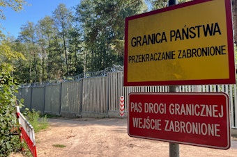 caption: In the middle of Poland's Bialowieza Forest, one of Europe's oldest remaining forests, stands Europe's newest border wall: a 15-foot-high metal fence topped with razor wire and security cameras. Poland finished building this fence a year ago to try to stem an influx of migrants assisted to the border by Belarusian soldiers, whose government is trying to destabilize Europe.