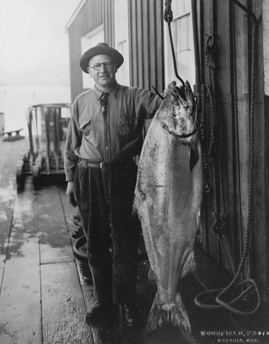 caption: Fisherman Tony Canessa with an 85-pound chinook he caught near Astoria, Oregon, in 1925.