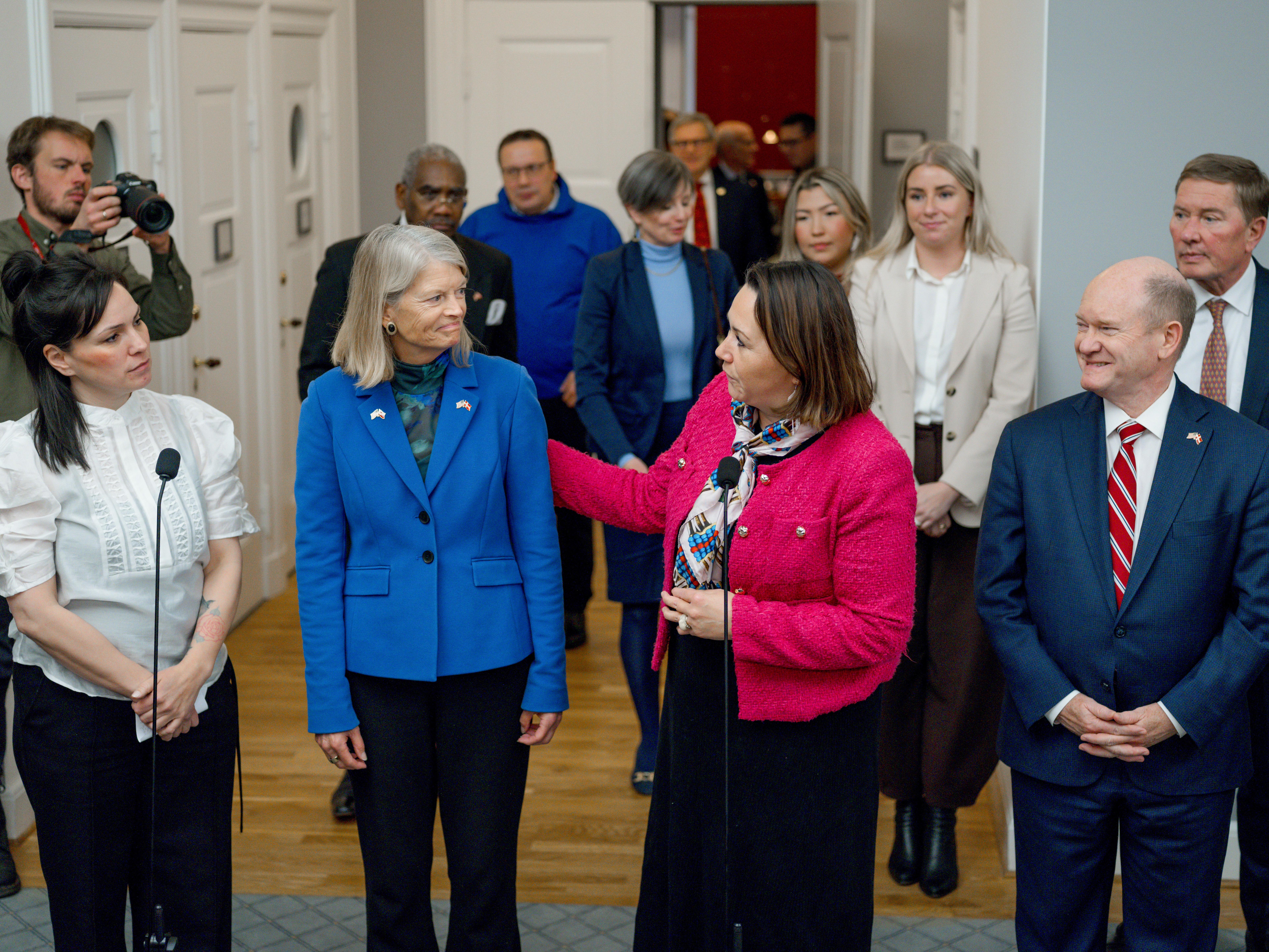 caption: Pipaluk Lynge, a Greenlandic politician; Sen. Lisa Murkowski, a Republican from Alaska; Aaja Chemnitz, a Greenlandic politician; and Sen. Chris Coons, a Democrat from Delaware, left to right, along with members from a U.S. congressional delegation at a news conference following a meeting at the parliament building in Copenhagen, Denmark, on Friday. Denmark and Greenland are stepping up lobbying of U.S. lawmakers in an effort to head off President Trump's push to take control of Greenland.