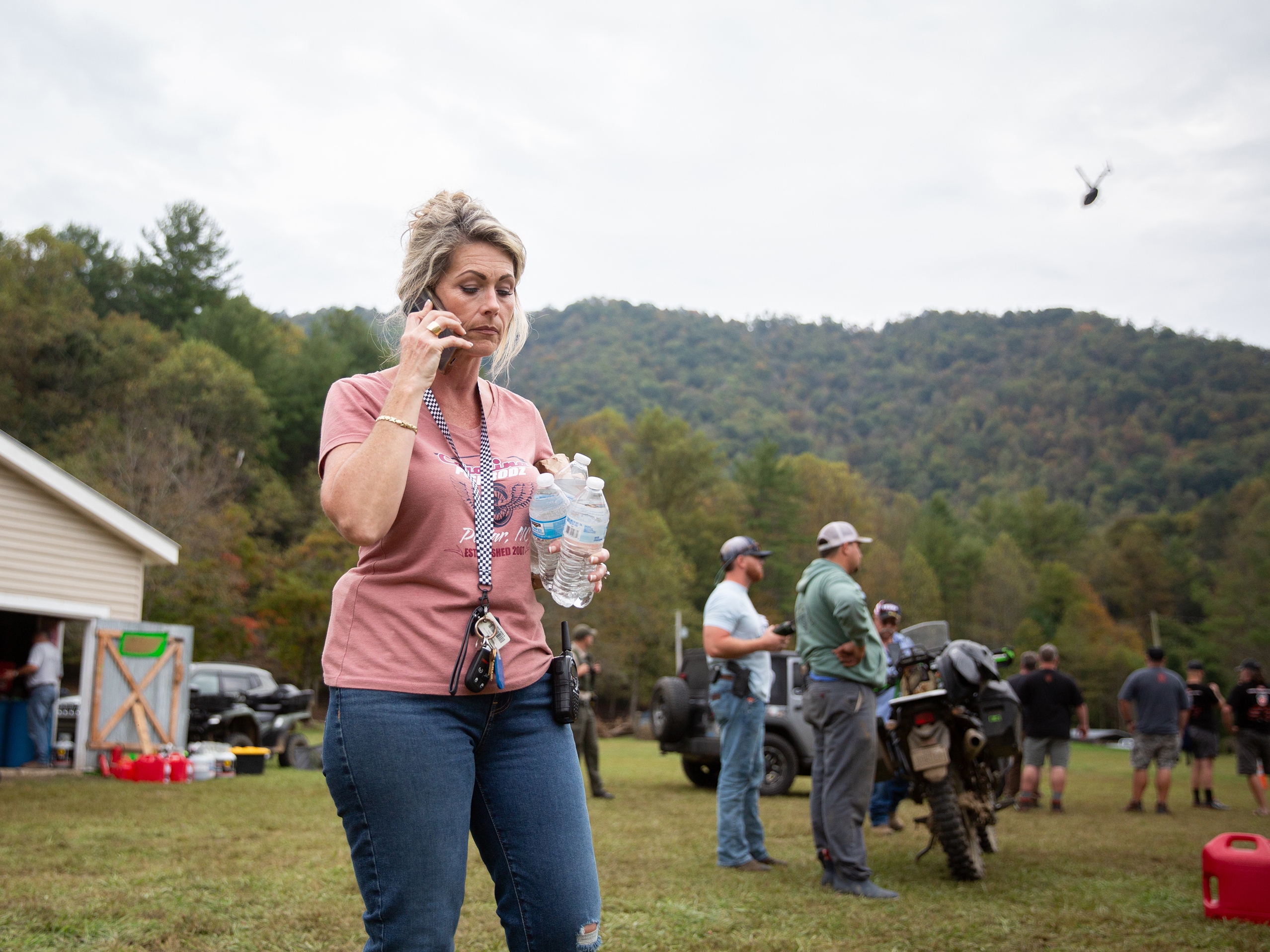 caption: Misty Hughes, a fifth-generation resident of Poplar, N.C., organizes flood relief efforts at the Poplar Community Center on Friday. The mountain hamlet sits along the Nolichucky River, which rose to record levels of flooding from Tropical Storm Helene.