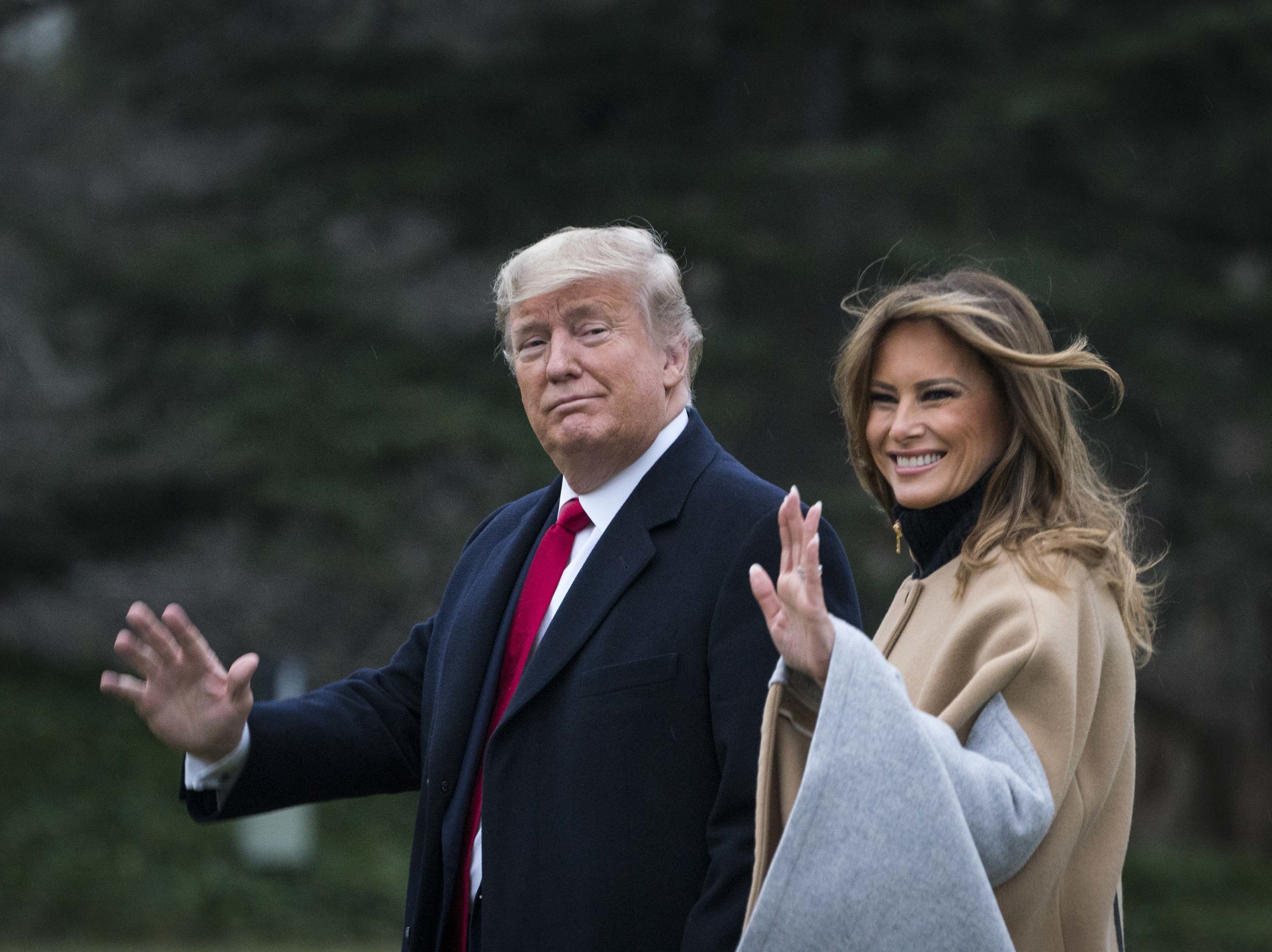 caption: President Trump and first lady Melania Trump walk along the South Lawn as they depart from the White House for a weekend trip to Mar-a-Lago in Florida on Friday.