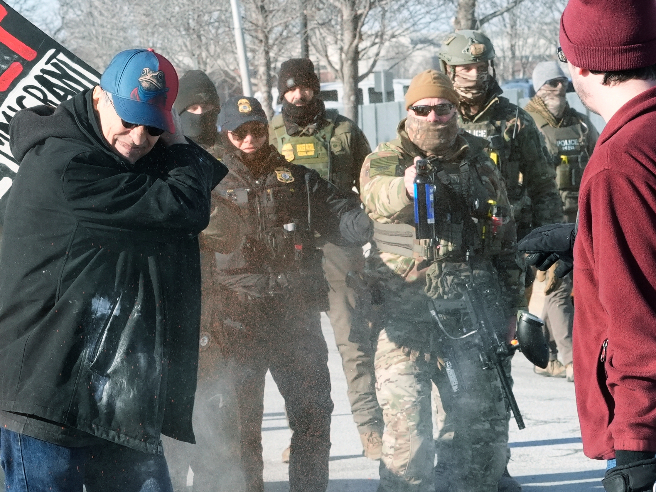 caption: Border Patrol police disperse pepper spray at demonstrators, Sunday, Jan. 11, 2026, in Minneapolis. (AP Photo/Jen Golbeck)