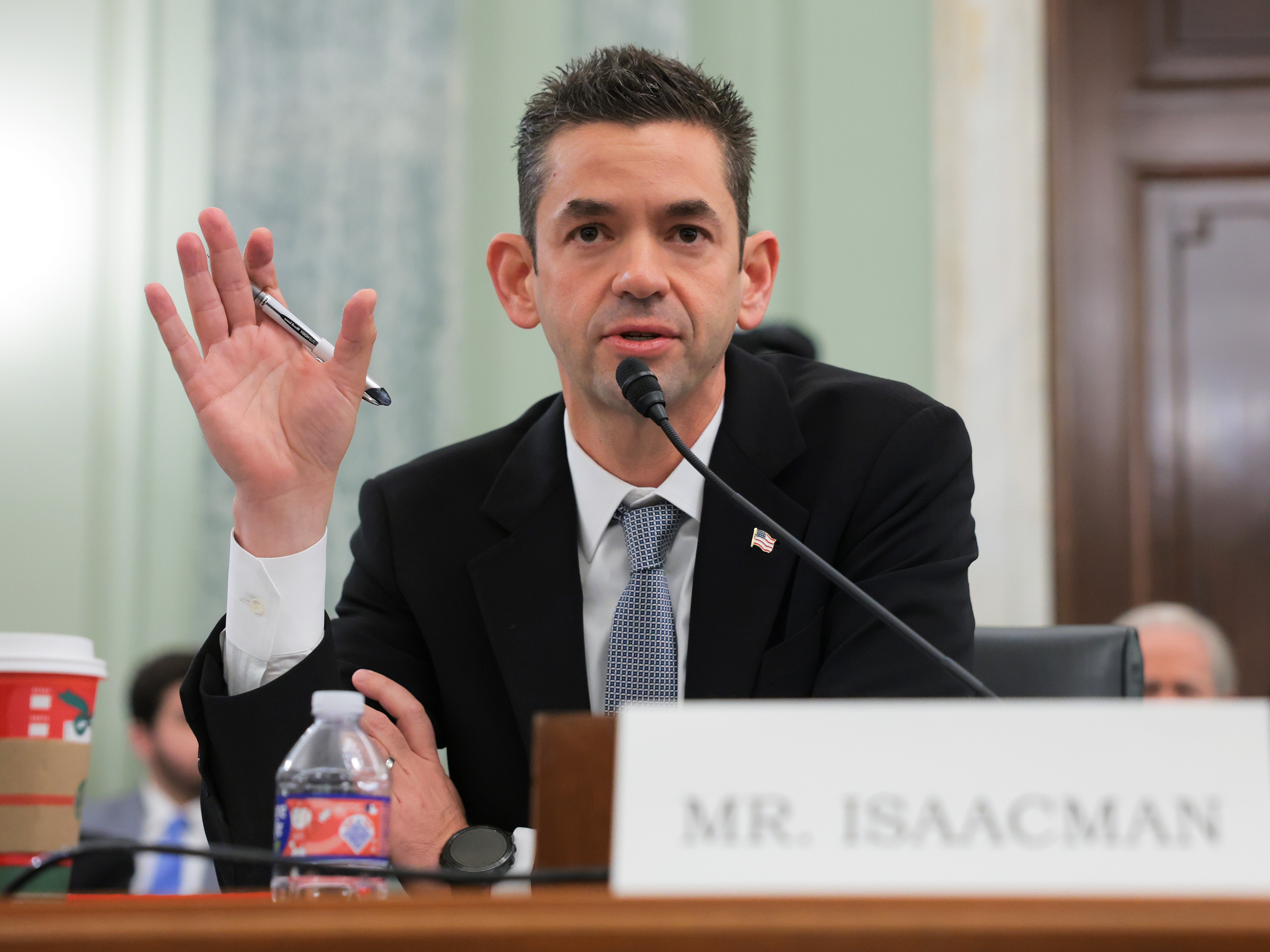 caption: Jared Isaacman testifies during his confirmation hearing on Capitol Hill in early December.