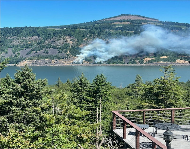 caption: The Tunnel 5 fire burns in Skamania County, Washington, on July 2, 2023, across the Columbia River from Hood River, Oregon.