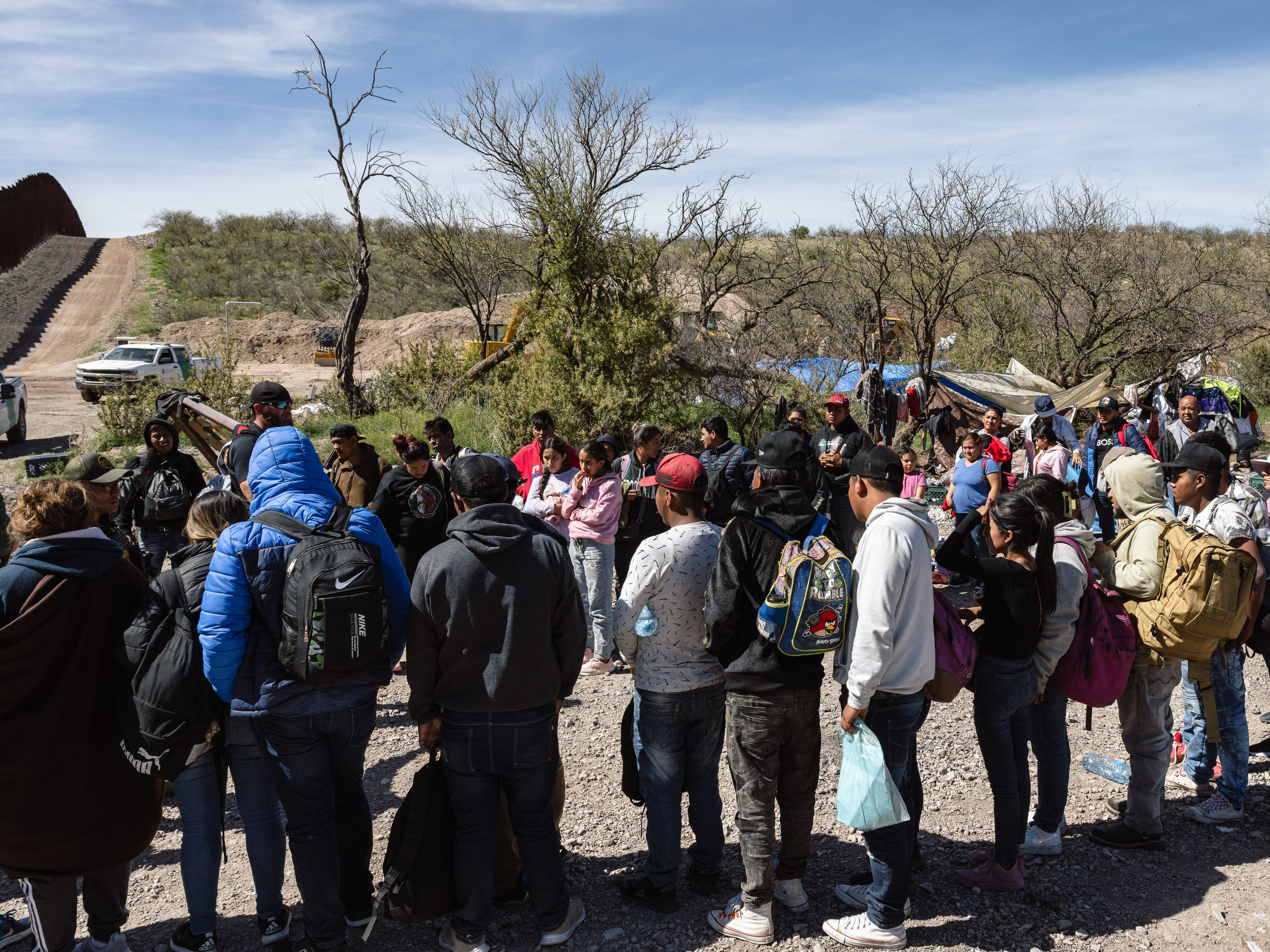 caption: Border Patrol picks up a group of people seeking asylum from an aid camp near Sasabe, Arizona, on Wednesday, March 13, 2024.