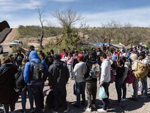 caption: Border Patrol picks up a group of people seeking asylum from an aid camp near Sasabe, Arizona, on Wednesday, March 13, 2024.