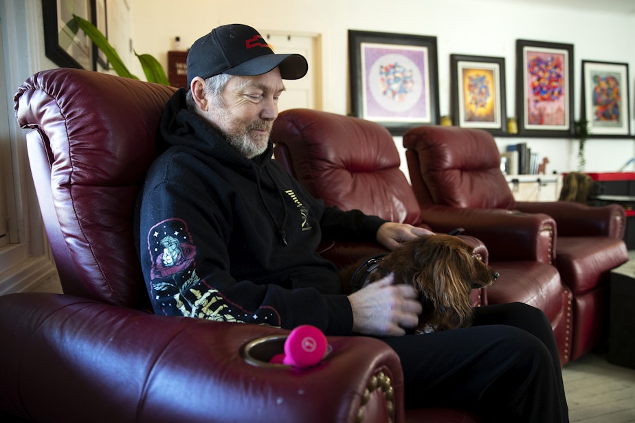 caption: Matt Kidd sits with his dog, Bentley, at his home on Friday, January 16, 2026, in Auburn.