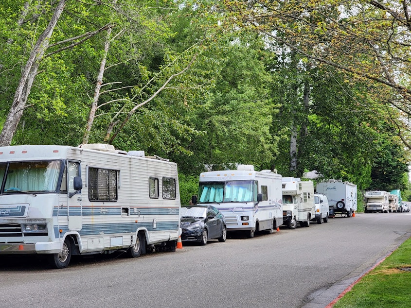 caption: A row of RVs and cars line the side of a road in Kirkland on Saturday, May 20, 2023. 