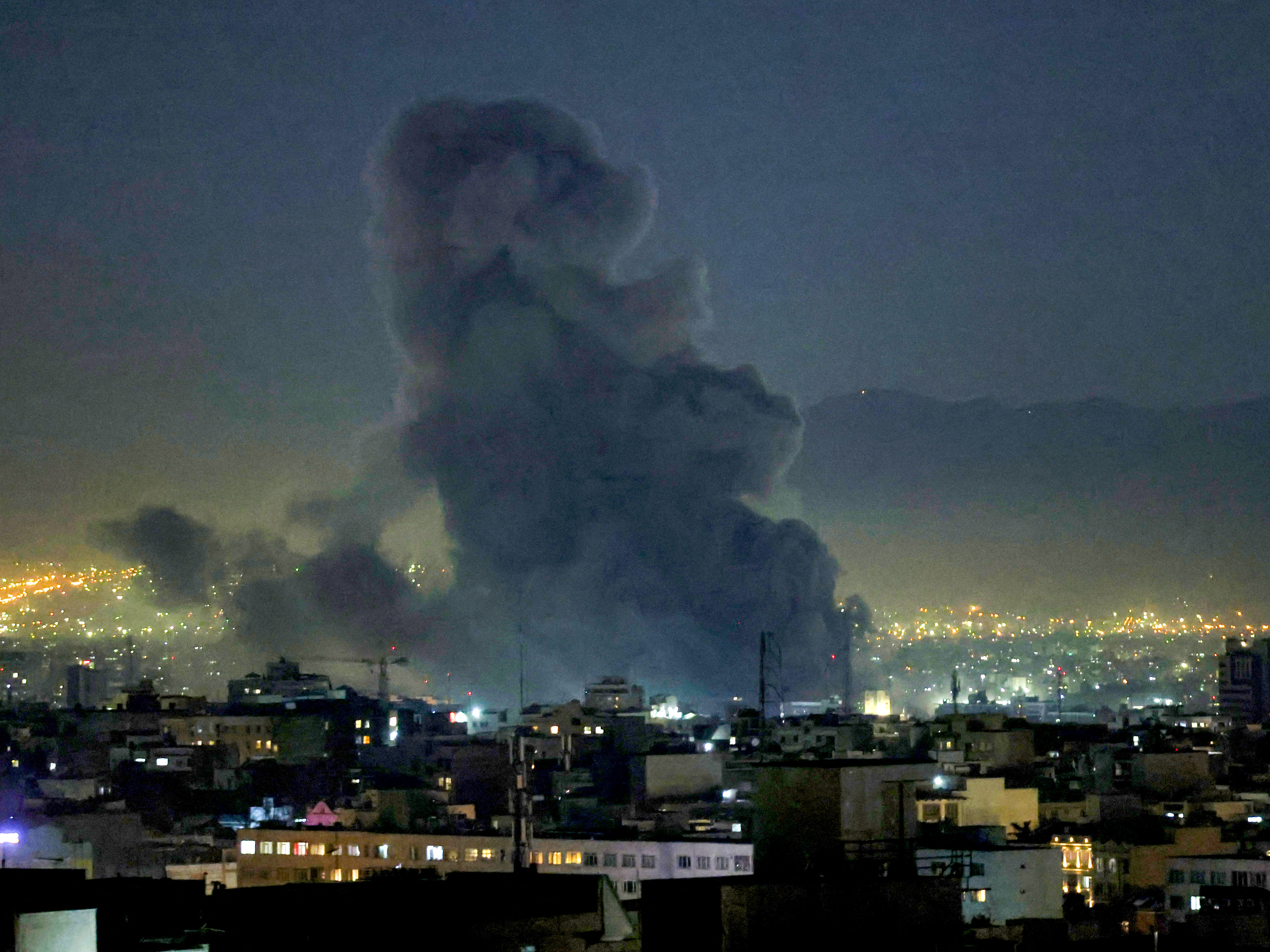 caption: Smoke plumes rise following missile strikes in Tehran on March 1, 2026. The United States and Israel launched strikes against Iran on February 28, killing Iran's supreme leader and top military leaders, prompting authorities to retaliate with strikes on Israel and US bases across the Gulf.