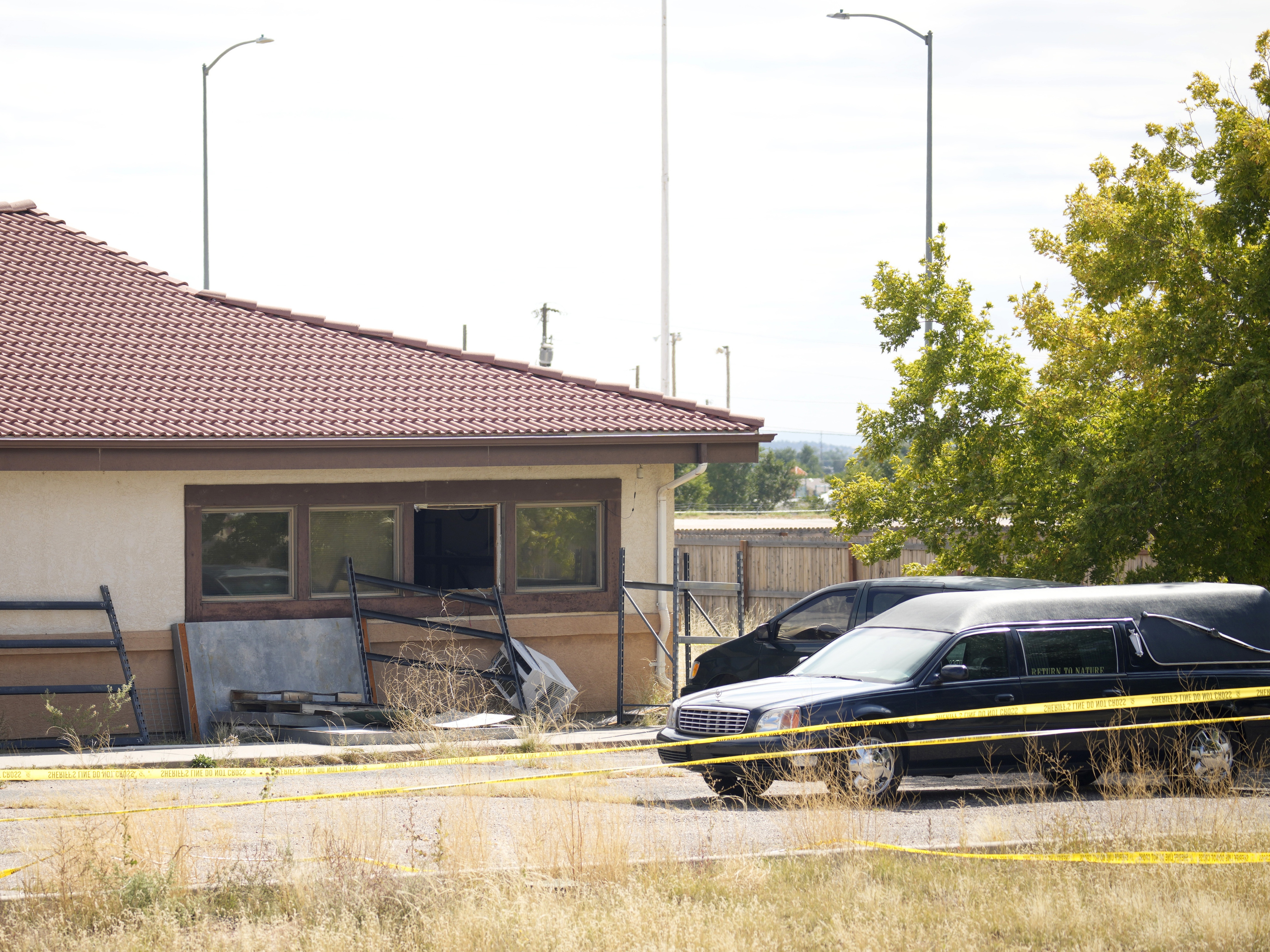 caption: A hearse and van sit outside the Return to Nature Funeral Home in Penrose, Colo., on Oct. 6, 2023. On Monday, a judge ordered the funeral home’s owners, Carie and Jon Hallford, to pay $950 million to families whose loved ones' remains were mishandled.
